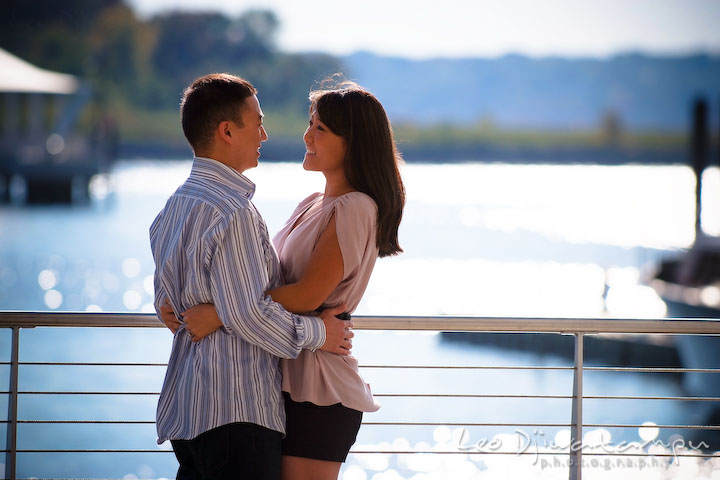 Fiancé and his fiancée holding each other. National Harbor, Gaylord National Hotel pre-wedding engagement photo session
