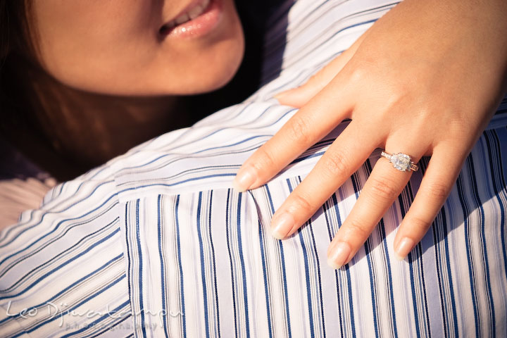 Fiancée hugging her fiancé and showing her diamond engagement ring. National Harbor, Gaylord National Hotel pre-wedding engagement photo session