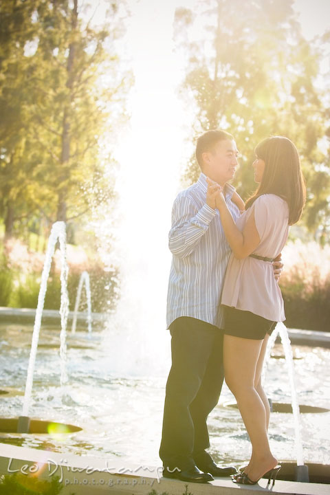 Engaged couple slow danced by the water fountain. National Harbor, Gaylord National Hotel pre-wedding engagement photo session