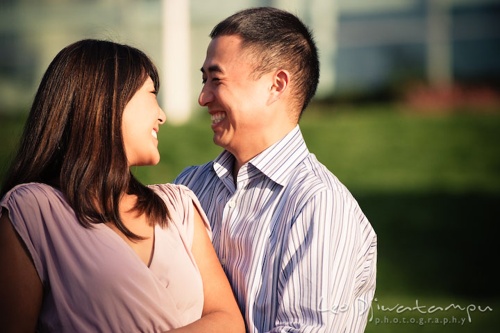 Engaged couple looking at each other and laughing. National Harbor, Gaylord National Hotel pre-wedding engagement photo session