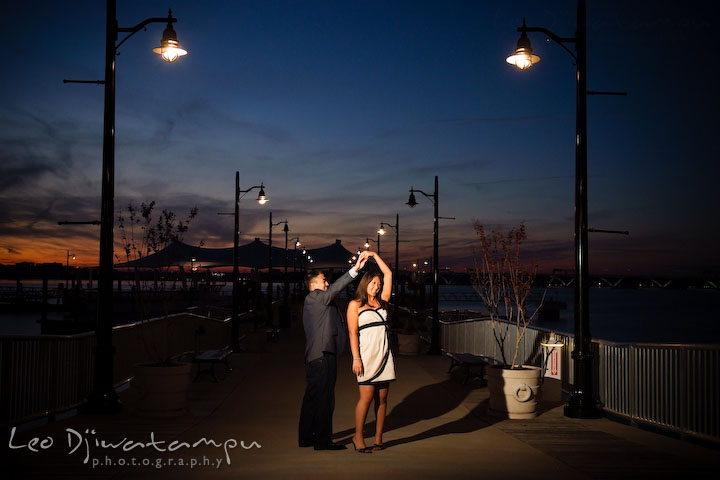 Engaged couple dancing on the pier. National Harbor, Gaylord National Hotel pre-wedding engagement photo session