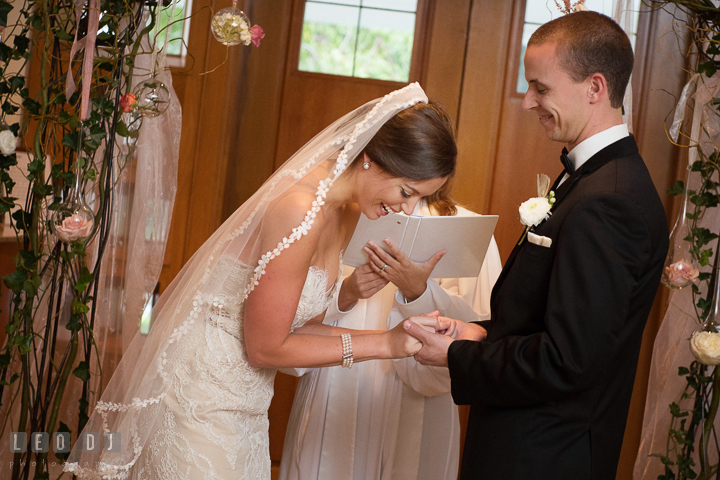 Bride laughing while Groom put on wedding ring. Aspen Wye River Conference Centers wedding at Queenstown Maryland, by wedding photographers of Leo Dj Photography. http://leodjphoto.com
