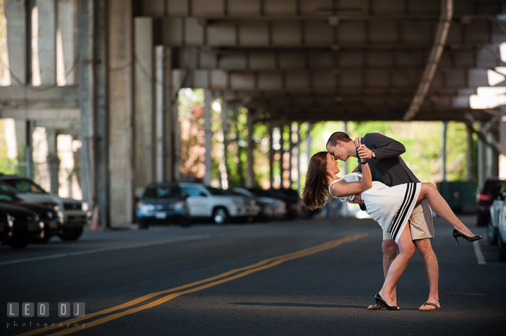 Engaged couple doing the dip under an overpass by the DC Waterfront. Georgetown Washington DC pre-wedding engagement photo session, by wedding photographers of Leo Dj Photography. http://leodjphoto.com