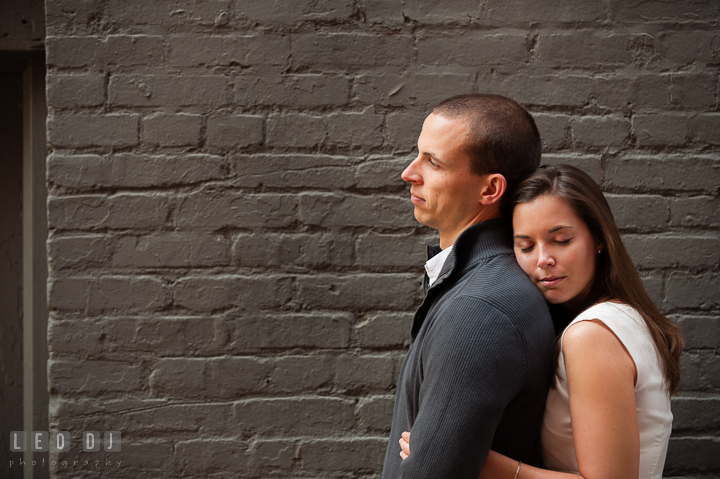 Engaged girl leaning her head on her fiancé's back. Georgetown Washington DC pre-wedding engagement photo session, by wedding photographers of Leo Dj Photography. http://leodjphoto.com