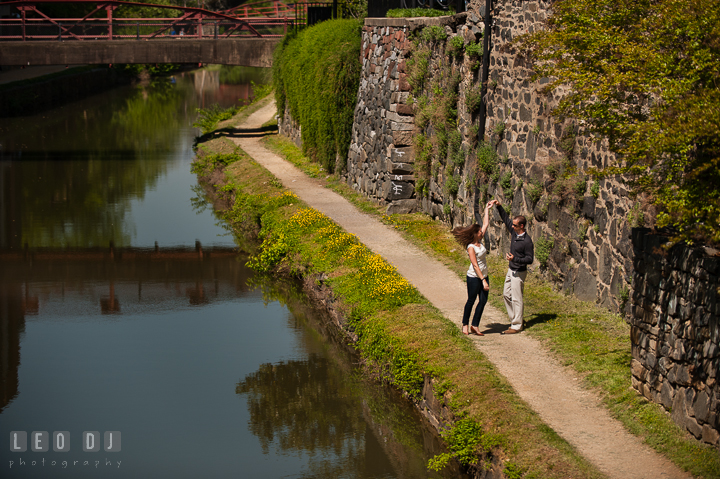 Engaged couple dancing by the C&O Canal. Georgetown Washington DC pre-wedding engagement photo session, by wedding photographers of Leo Dj Photography. http://leodjphoto.com