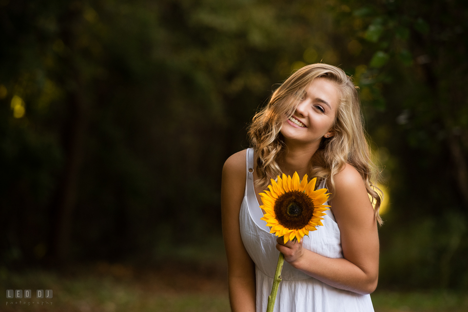 Kent Island High School Maryland senior with sunflower laughing photo by Leo Dj Photography