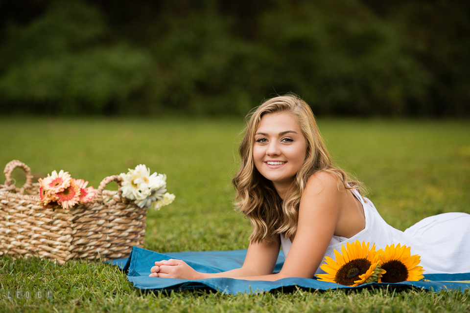 Kent Island High School Maryland senior with basket of flowers laying on ground photo by Leo Dj Photography