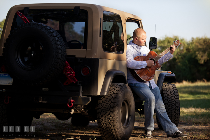 Boy playing guitar while sitting on his SUV. Eastern Shore, Maryland, Kent Island High School senior portrait session by photographer Leo Dj Photography. http://leodjphoto.com