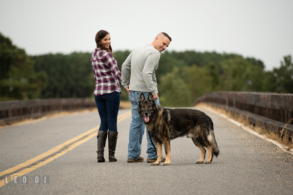 Wye Island Queenstown Maryland engaged man walking with his fiancée and dog photo by Leo Dj Photography.