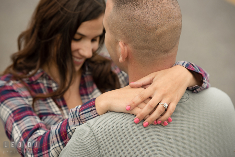 Wye Island Queenstown Maryland engaged girl embraced her fiancé and showed her engagement ring photo by Leo Dj Photography.