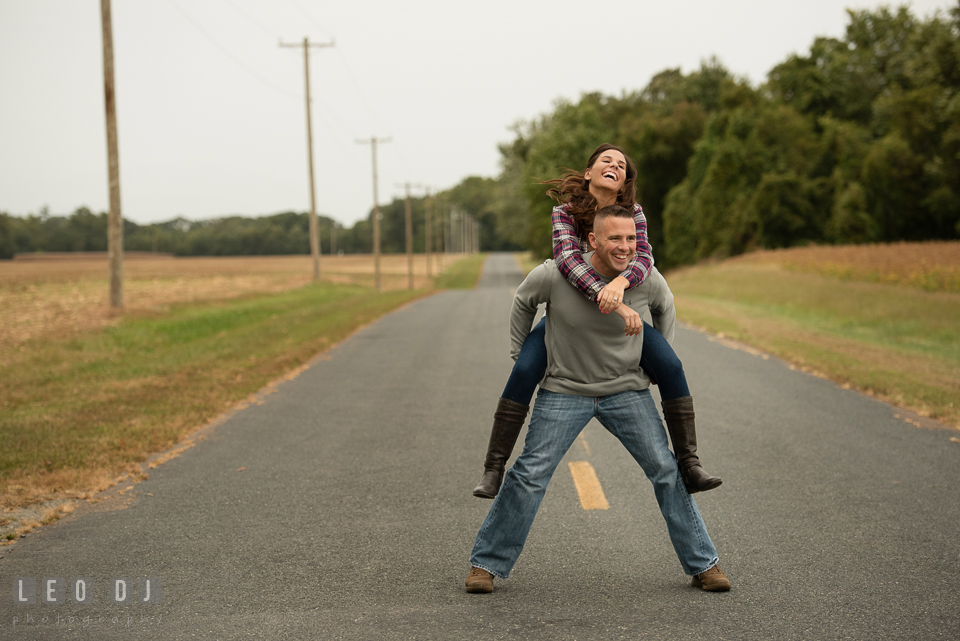 Wye Island Queenstown Maryland engaged girl piggyback riding with her fiancé photo by Leo Dj Photography.