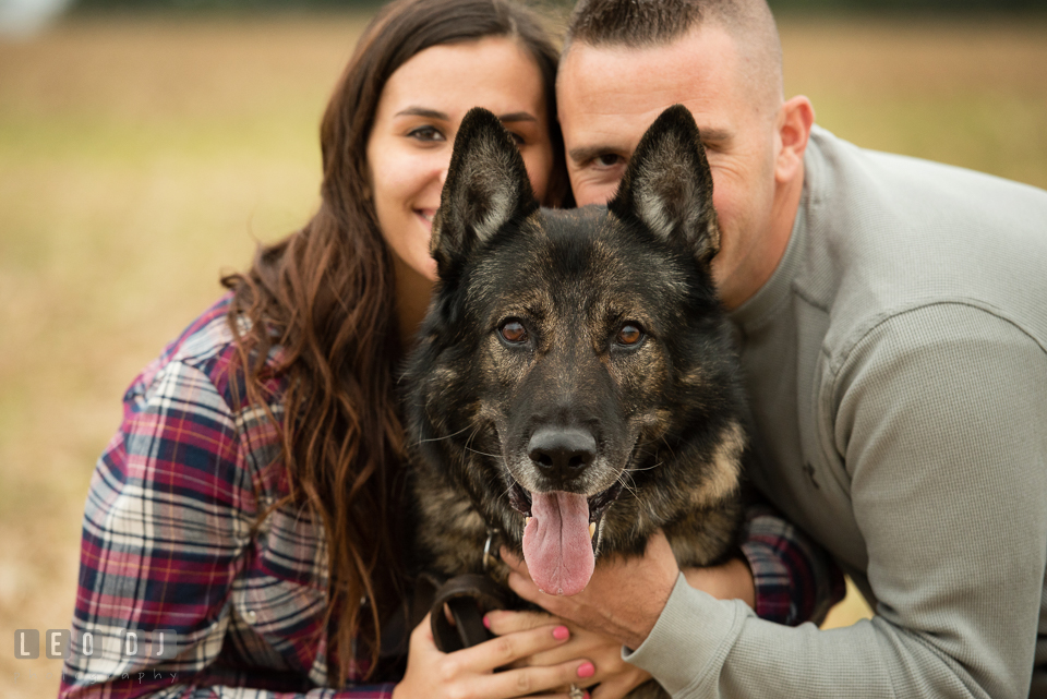 Wye Island Queenstown Maryland guy and girl hiding behind their dog engagement photo by Leo Dj Photography.